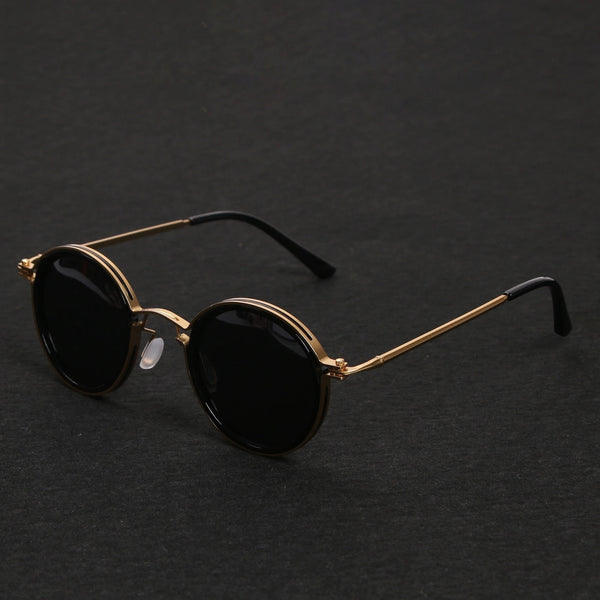 Gafas de sol redondas con patillas doradas